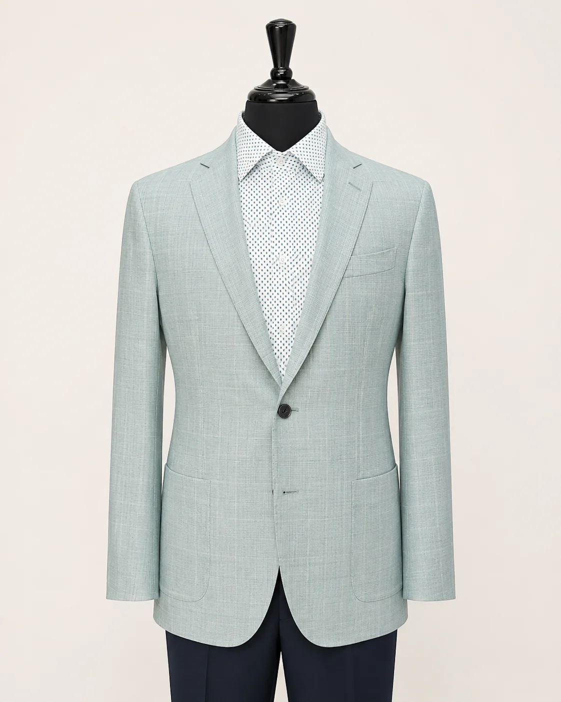Light blue tailored jacket displayed on a black mannequin with a patterned dress shirt.