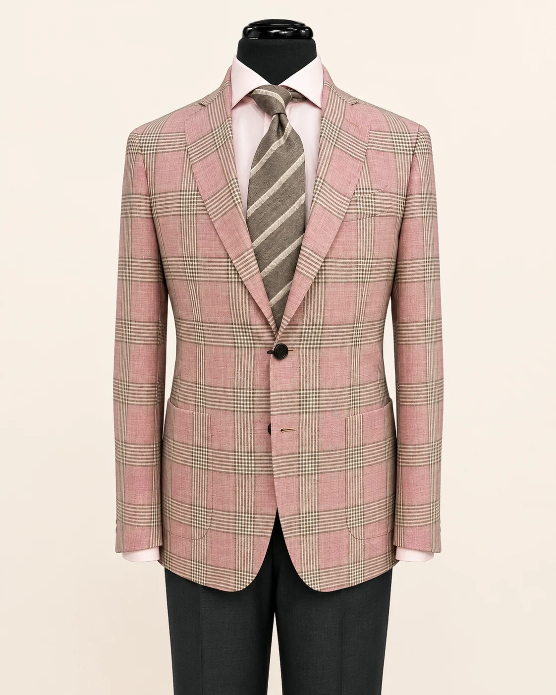 Pink plaid sport coat displayed on a black mannequin with pink shirt and striped tie.